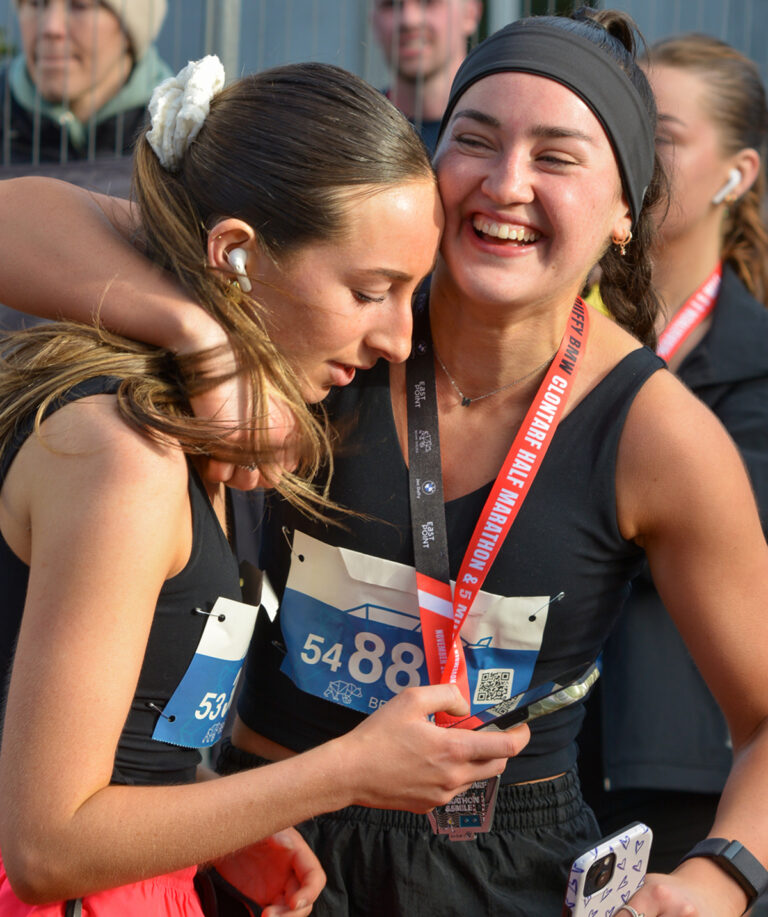 women hugging after run