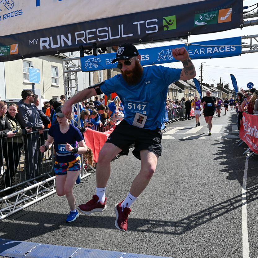 man jumping at the end of the race